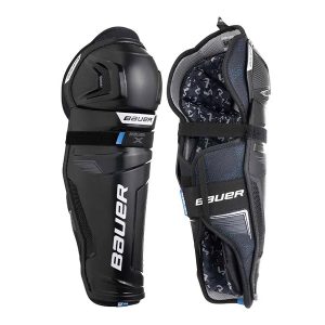 Two Bauer X Shin Guards in black are shown—one highlights the exterior front, while the other displays the interior padding and strap system.